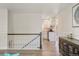 Staircase leading to a living room with a view into the kitchen at 7282 S Vance St, Littleton, CO 80128