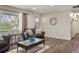 Inviting living room featuring hardwood floors, a stylish coffee table and a large window at 7282 S Vance St, Littleton, CO 80128