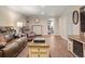 Inviting living room with contemporary decor, wood-look floors, and comfortable leather seating at 7282 S Vance St, Littleton, CO 80128