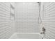 Clean, modern bathroom with a subway-tiled shower and built-in niche for toiletries at 3365 Chisholm Trl # B102, Boulder, CO 80301