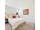 Cozy bedroom with carpet and a bed with white bedding and decoratively framed flower art at 3365 Chisholm Trl # B102, Boulder, CO 80301