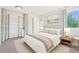 Tastefully styled bedroom featuring a bed, nightstands, wardrobe, and a view from the window at 3365 Chisholm Trl # B102, Boulder, CO 80301