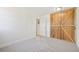 Inviting bedroom space featuring carpet, and a unique wooden sliding barn door wardrobe at 3365 Chisholm Trl # B102, Boulder, CO 80301