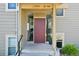 Exterior view showing a front door entrance with gray siding and stone accents at 3365 Chisholm Trl # B102, Boulder, CO 80301