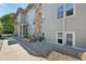 Apartment building shows stone accents, light gray siding, and well-maintained landscaping at 3365 Chisholm Trl # B102, Boulder, CO 80301