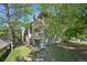 View of condo exterior featuring balconies and landscaping, nestled among mature trees for a peaceful setting at 3365 Chisholm Trl # B102, Boulder, CO 80301