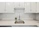 Clean kitchen area features white backsplash, countertop space, and stainless steel sink at 3365 Chisholm Trl # B102, Boulder, CO 80301