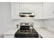 Bright kitchen features stainless steel appliances, white cabinets, and an electric range at 3365 Chisholm Trl # B102, Boulder, CO 80301