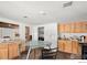 Cozy kitchenette with light wood cabinets and a glass top table, offering a simple yet functional space at 3365 Chisholm Trl # B102, Boulder, CO 80301