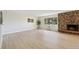 Inviting living room with wood-style flooring, stone fireplace, and ample natural light at 3365 Chisholm Trl # B102, Boulder, CO 80301