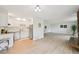 Open-concept living space with a modern kitchen featuring white cabinets and stainless steel appliances at 3365 Chisholm Trl # B102, Boulder, CO 80301