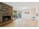 Relaxing living room with stone fireplace, wood floors, and access to the kitchen at 3365 Chisholm Trl # B102, Boulder, CO 80301