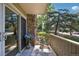 Ground floor patio with sliding glass door and stone detail with view of landscaped community at 3365 Chisholm Trl # B102, Boulder, CO 80301