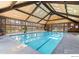 Indoor pool boasts a vaulted ceiling, wooden beams, and large windows offering ample natural light at 3365 Chisholm Trl # B102, Boulder, CO 80301