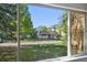 Window view of manicured lawn, mountains, and a neighboring building in this inviting community at 3365 Chisholm Trl # B102, Boulder, CO 80301