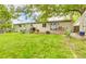 Expansive backyard with lush lawn, patio, and mature shade tree creates a private outdoor retreat at 4665 E Peakview Ave, Centennial, CO 80121