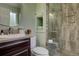 Bathroom featuring glass shower with tile surround and vanity with dark wood cabinets at 4665 E Peakview Ave, Centennial, CO 80121