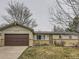 Charming single-story home featuring a well-manicured lawn, brick accents, and a two-car attached garage at 4665 E Peakview Ave, Centennial, CO 80121