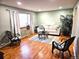 Inviting living room boasts hardwood floors, a comfy sofa, stylish chairs, and a large window with natural light at 4665 E Peakview Ave, Centennial, CO 80121