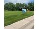 A well-manicured park with lush grass, shade trees, and walking paths is a neighborhood treasure at 4665 E Peakview Ave, Centennial, CO 80121