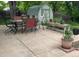 Spacious stamped concrete patio with outdoor dining set, shed and landscaped greenery, perfect for relaxing or entertaining at 4665 E Peakview Ave, Centennial, CO 80121