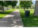 Walking path through a grassy park lined with trees, providing a serene and enjoyable outdoor recreation area at 4665 E Peakview Ave, Centennial, CO 80121