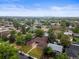 Scenic aerial view of a neighborhood with tree-lined streets and a distant city skyline at 3555 Leyden St, Denver, CO 80207
