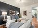 Stylishly decorated bedroom with a plush bed, modern art, and a cozy atmosphere at 3555 Leyden St, Denver, CO 80207