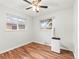 Minimalist bedroom with hardwood floors, large windows, and a portable air conditioner at 3555 Leyden St, Denver, CO 80207