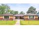 Charming single-story home featuring a well-manicured lawn and brick accents at 3555 Leyden St, Denver, CO 80207