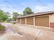 Spacious three-car garage with brown doors and a concrete driveway, offering ample parking and storage at 3555 Leyden St, Denver, CO 80207