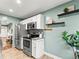 Well-appointed kitchen with stainless steel appliances and stylish open shelving at 3555 Leyden St, Denver, CO 80207