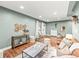 Open-concept living room boasting stylish furnishings, plants, and natural light at 3555 Leyden St, Denver, CO 80207