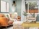 Inviting living room with a brown leather sofa, soft textures, and large window at 3555 Leyden St, Denver, CO 80207