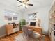 Bright home office featuring built-in shelving, a wooden desk, and ample natural light at 3555 Leyden St, Denver, CO 80207