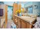 Bathroom with a spacious vanity, warm tile accents, and a large mirror for a bright and inviting space at 6100 Bear Paw Rd, Golden, CO 80403