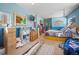 Bright bedroom with blue walls featuring art; two beds, dressers, and a carpet, conveying comfort at 6100 Bear Paw Rd, Golden, CO 80403