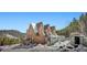 Charming three-story home showcasing its unique architecture and wintery surroundings at 6100 Bear Paw Rd, Golden, CO 80403
