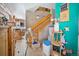 A bright hallway with a staircase and tiled floor providing seamless transition between spaces at 6100 Bear Paw Rd, Golden, CO 80403