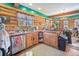 Rustic log kitchen with wooden cabinets, ample counter space, and scenic views from the windows at 6100 Bear Paw Rd, Golden, CO 80403