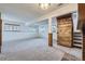 Spacious basement with carpet, natural light from windows, and rustic wood beam accents at 9374 W Friend Dr, Littleton, CO 80128