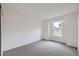 Carpeted bedroom with a large window providing natural light and outdoor views at 9374 W Friend Dr, Littleton, CO 80128
