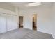 Bedroom with carpet, skylight, closet, and an open doorway to the attached bathroom at 9374 W Friend Dr, Littleton, CO 80128