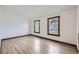 A bright bedroom with wood-look flooring and two windows overlooking the lawn at 9374 W Friend Dr, Littleton, CO 80128