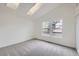Sunlit bedroom with plush carpeting, vaulted ceilings, skylights, and double windows offering backyard views at 9374 W Friend Dr, Littleton, CO 80128
