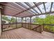 A spacious wooden deck featuring a pergola, railing and an outdoor living space at 9374 W Friend Dr, Littleton, CO 80128