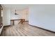 Open loft area with light wood-look floors and a wooden railing overlooking lower floor at 9374 W Friend Dr, Littleton, CO 80128