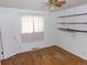 Simple bedroom featuring hardwood floors, a window, and basic shelving at 680 Kalmia Way, Broomfield, CO 80020