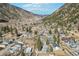 Wide aerial view of a town nestled in a valley surrounded by lush green mountains on a sunny day at 916 Griffith St, Georgetown, CO 80444