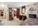 Quaint bedroom with floral wallpaper, a decorative mirror, and a cozy, patterned bedspread at 916 Griffith St, Georgetown, CO 80444